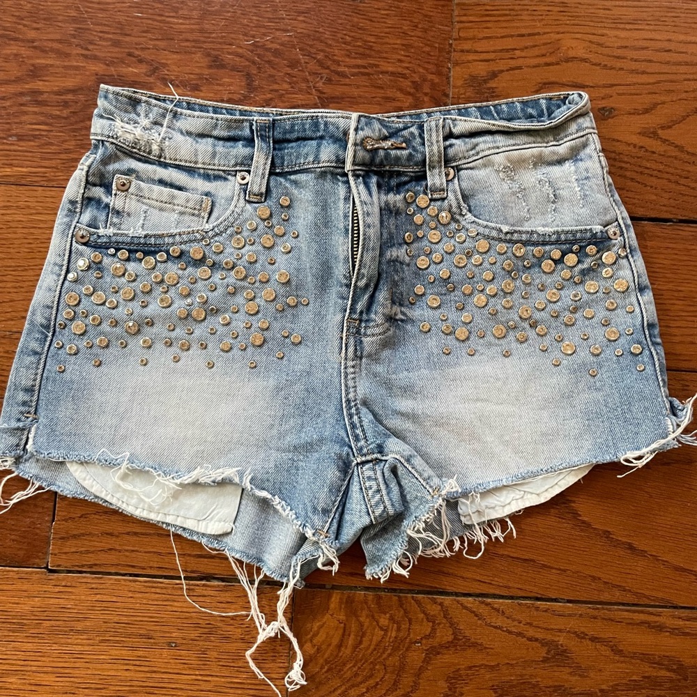 Pistols women’s jean shorts with silver grommet/rhinestone detail. Size 24.